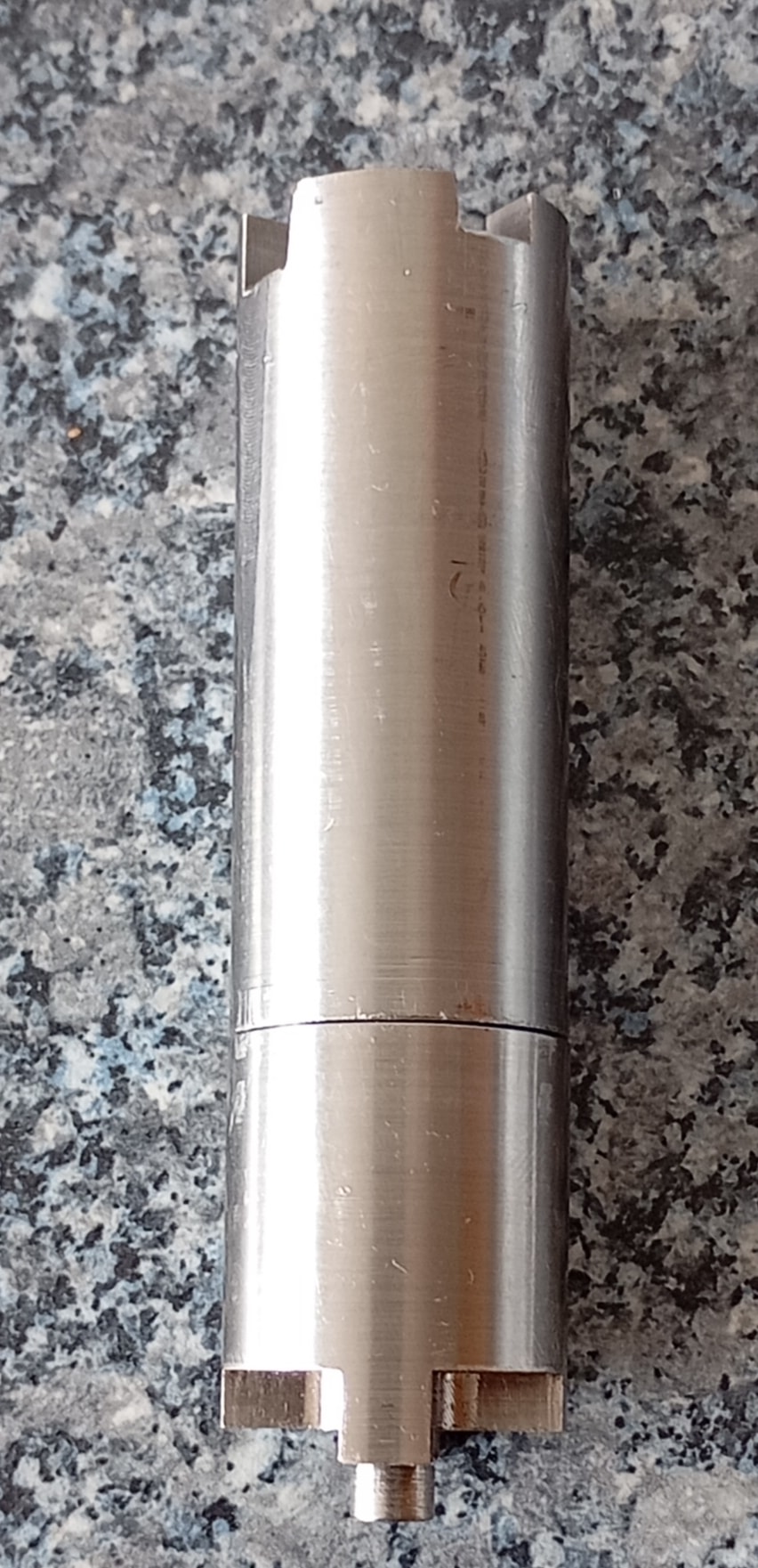 Close-up of precision CNC machined metal parts with detailed threaded surfaces